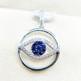 A pendant with an evil eye design featuring blue gemstones and encrusted with Diamond Made with 925 Silver