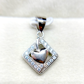 A silver heart-shaped pendant with a diamond-encrusted frame