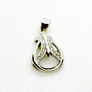 A silver pendant in the shape of an abstract design with embedded diamonds