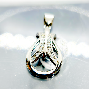 A silver pendant in the shape of an abstract design with embedded diamonds