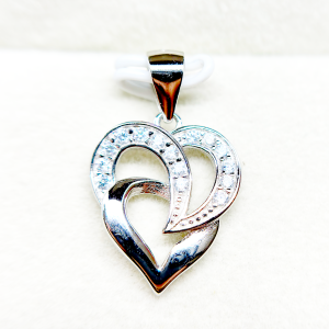 A silver heart-shaped pendant with an intertwined design and small diamonds