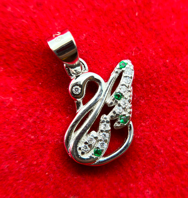 " Silver and green gemstone pendant in the shape of an abstract figure"