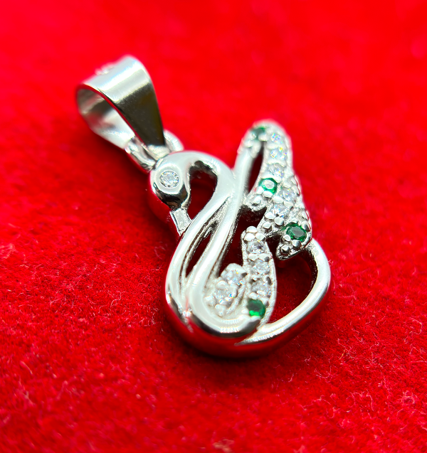 " Silver and green gemstone pendant in the shape of an abstract figure"