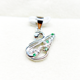 Silver and green diamond pendant in the shape of an abstract figure