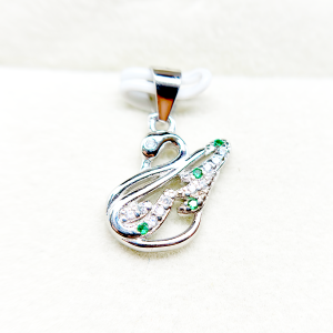 " Silver and green gemstone pendant in the shape of an abstract figure"