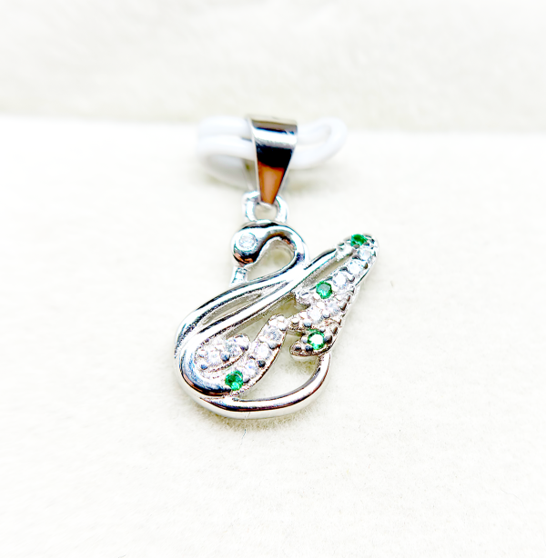 " Silver and green gemstone pendant in the shape of an abstract figure"