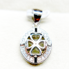 Close-up of a silver pendant with a heart-shaped cutout and a clover design, encrusted with small diamonds