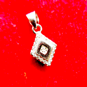 A square-shaped pendant with a concentric diamond design, surrounded by smaller diamonds