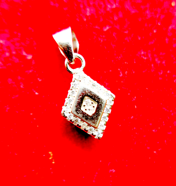 A square-shaped pendant with a concentric diamond design, surrounded by smaller diamonds