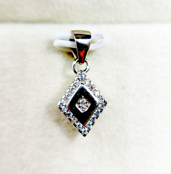 A square-shaped pendant with a concentric diamond design, surrounded by smaller diamonds