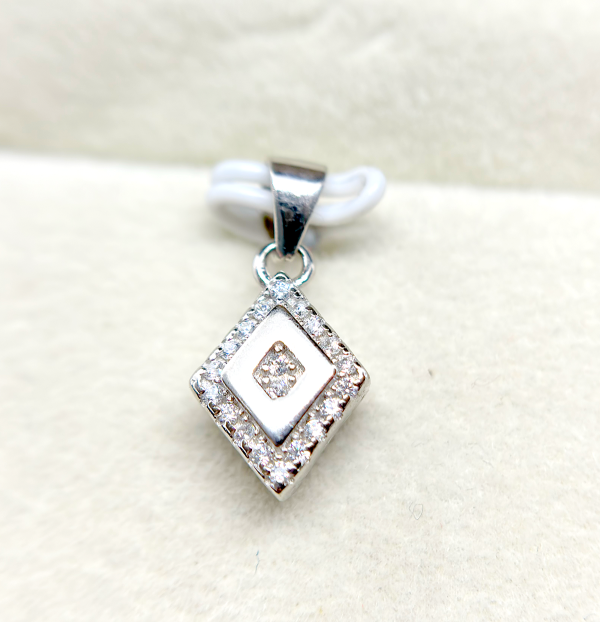 A square-shaped pendant with a concentric diamond design, surrounded by smaller diamonds