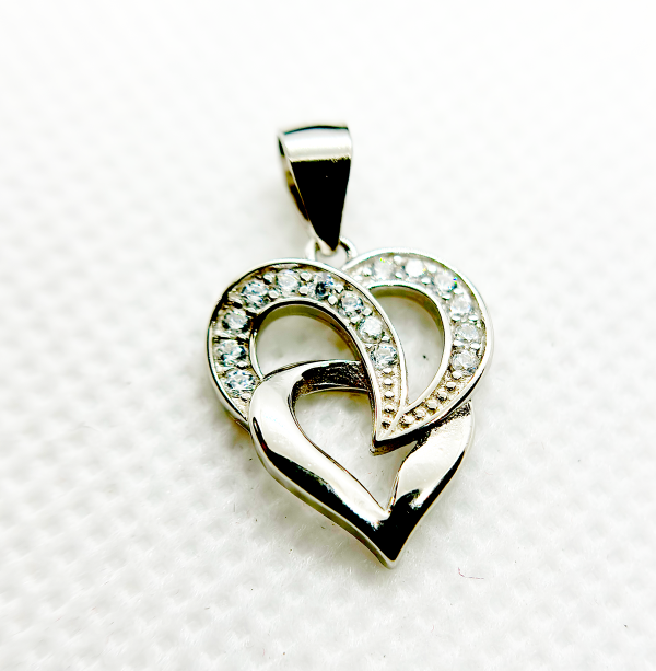 A silver heart-shaped pendant with an intertwined design and small diamond