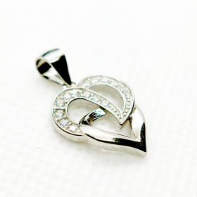 A silver heart-shaped pendant with an intertwined design and small diamonds