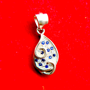 A silver teardrop-shaped pendant with blue gemstones