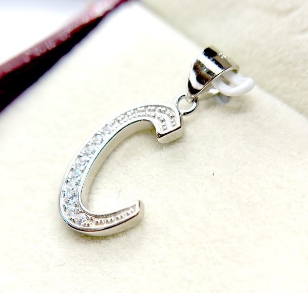Silver letter C pendant with embedded diamonds
