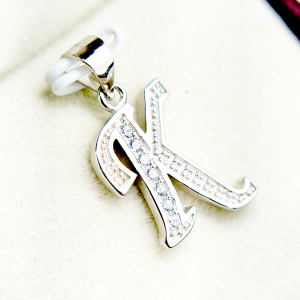 Silver letter K pendant with embedded diamonds